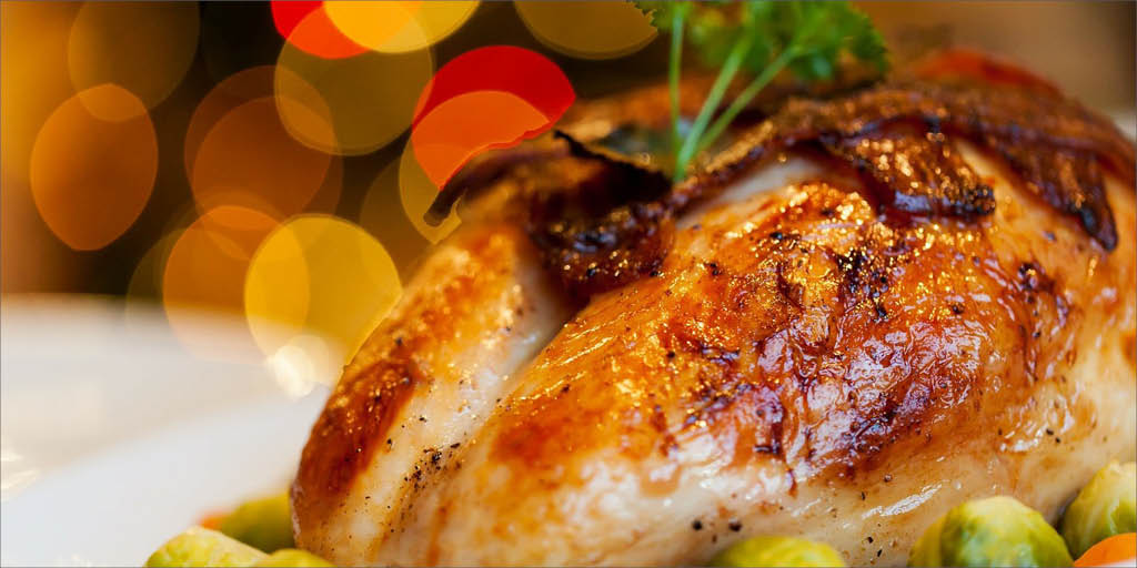 a roast turkey with a festive background