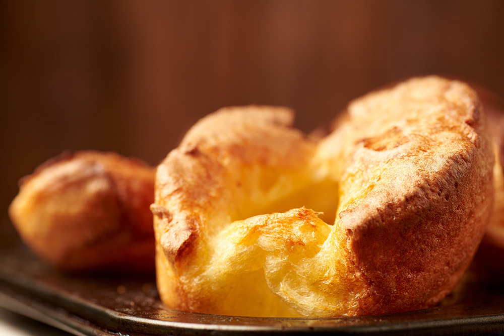 freshly baked and beautifully risen Yorkshire puddings in the baking tray