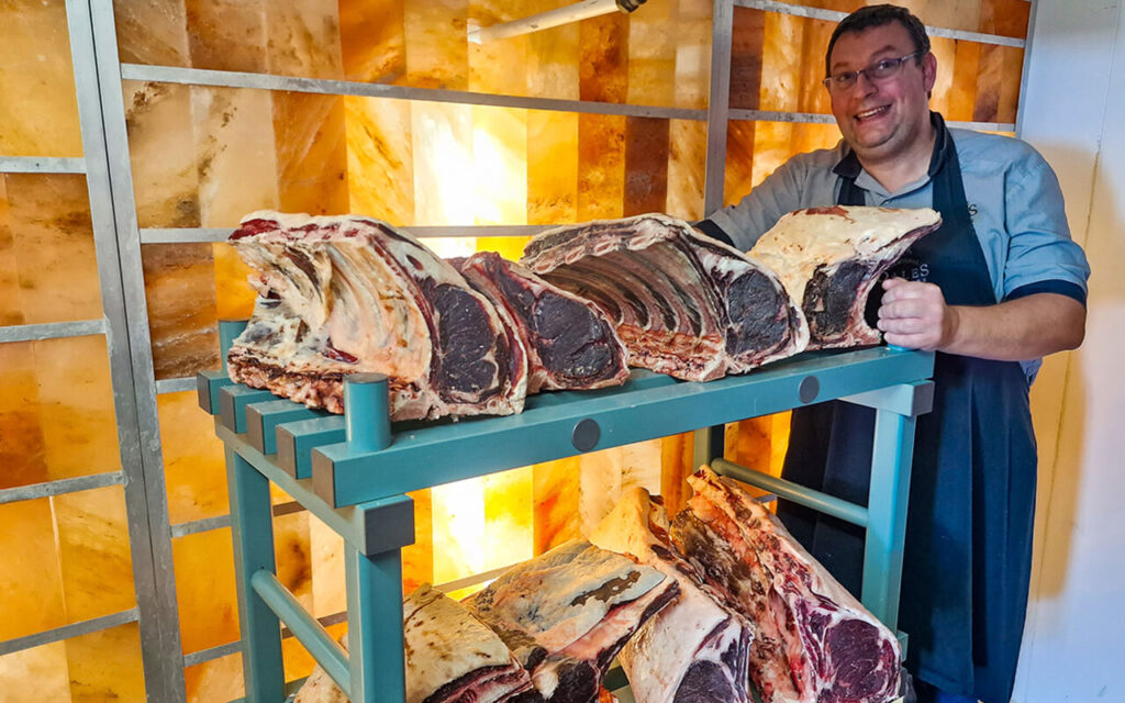 Owner, Mark Duckworth showing off his Himalayan salt wall dry-ageing chamber at Dales Butchers in Cumbria