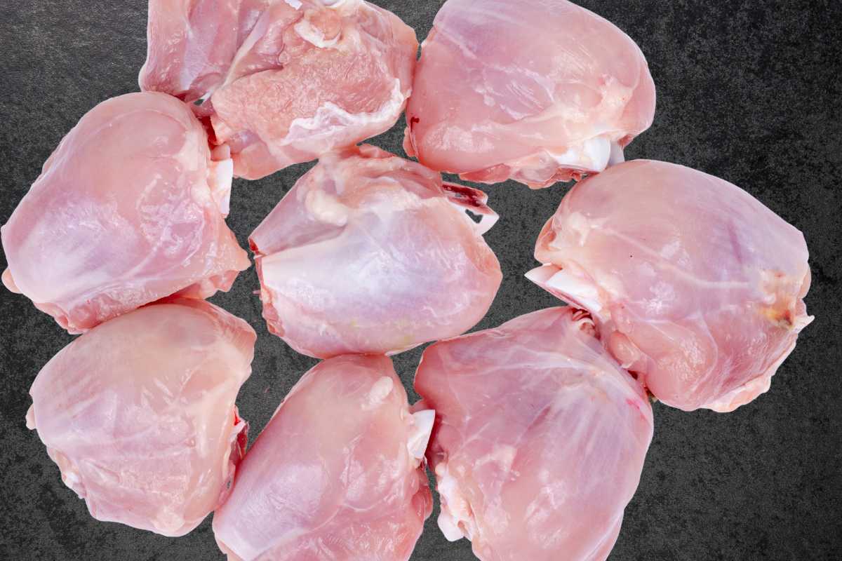 raw chicken thighs on a slate background